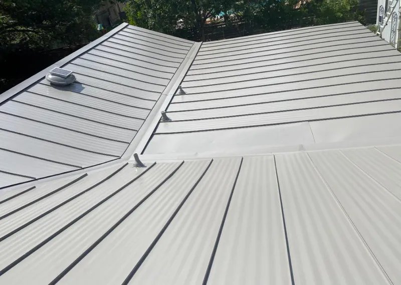 Solar attic fan installed on a metal roof for Roof Ventilation in Saks